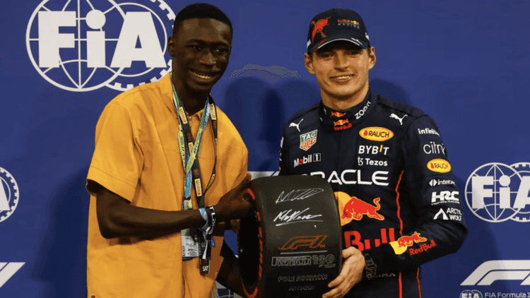 Khaby Lame présente le pneu de la pole position à Max Verstappen lors du GP d'Abou Dabi 2022
