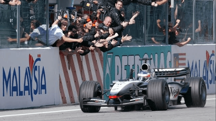Kimi Räikkönen remporte sa première victoire F1 à Sepang en 2003, célébrant avec son équipe McLaren