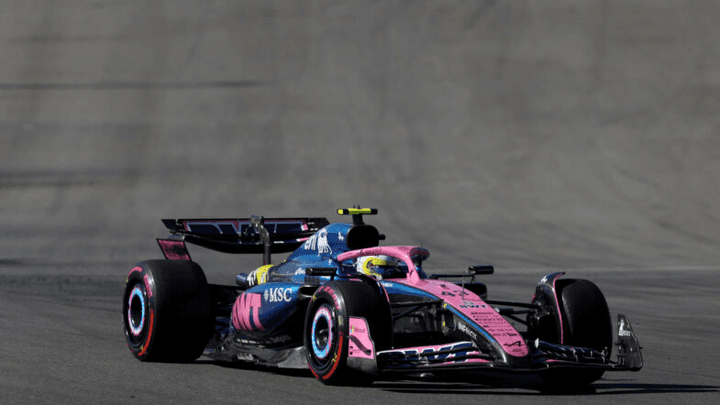 Voiture de F1 Alpine rose et bleue en action sur circuit