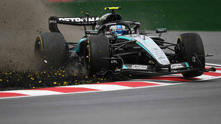 Voiture de F1 Mercedes sortant de piste dans un nuage de débris et de poussière